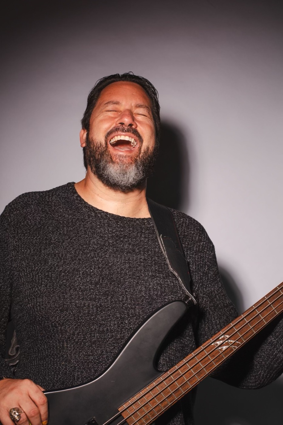 Eric Marcoullier, laughing, playing bass